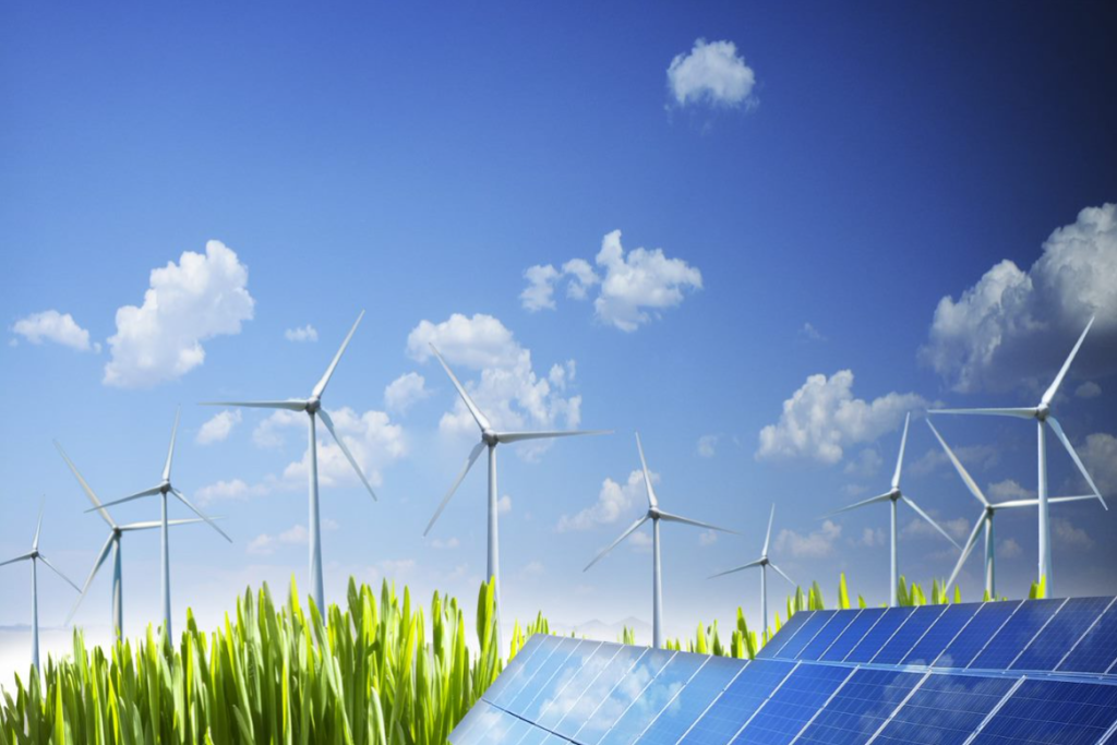 Aerial view of wind turbines and solar panels in the field. Image courtesy of ISN.