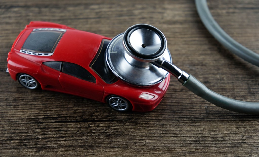 A stethoscope 'listens' to a toy car. Source: Shutterstock/bobbery