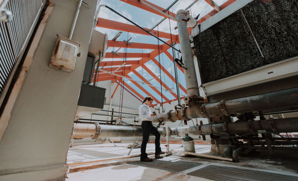 A Carbon Lighthouse engineer collects energy data from a cooling tower at a Honolulu shopping center.