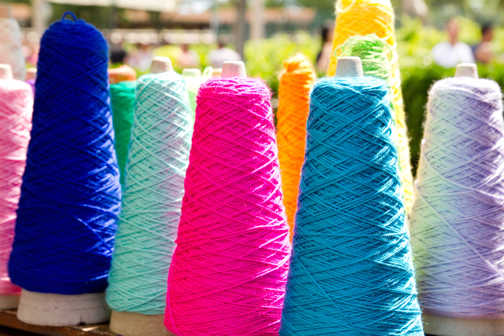 Rows of colorful thread on spools