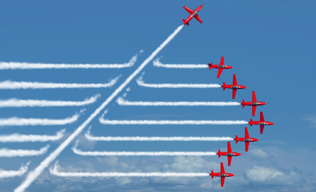 Photo of an airplane flying out of line with others