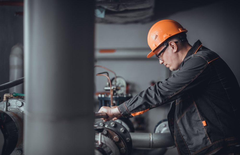 Worker repairing pipes