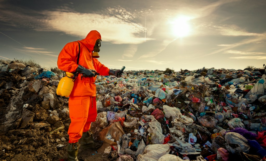 Environmental engineer measuring air pollution at a landfill