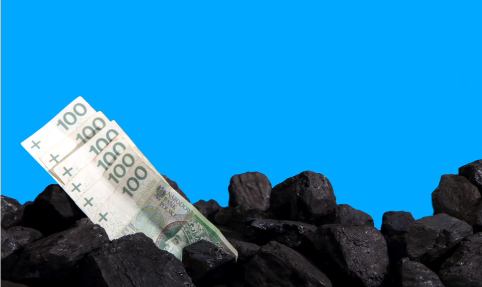 Paper money lies on black coal