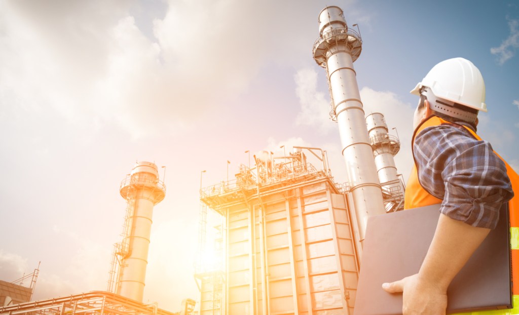 Person looking up at power plant