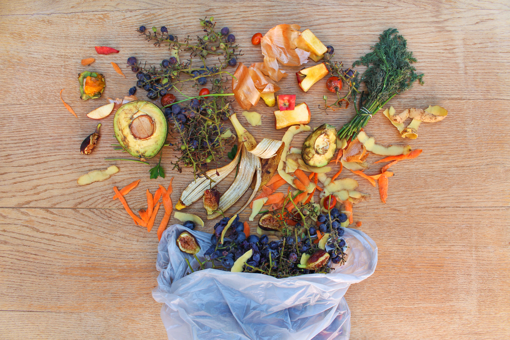 Aerial view of fruit and vegetable waste for compost in the garbage bag on the table.