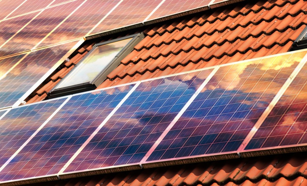 Solar panels on a barrel tile roof.