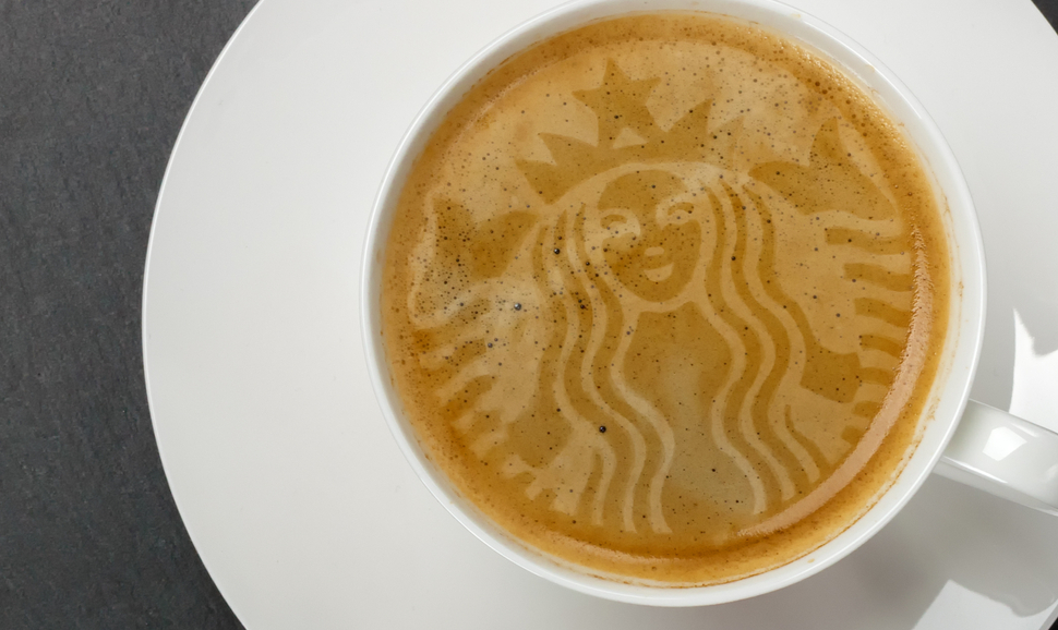 A latte with the Starbucks logo in the foam