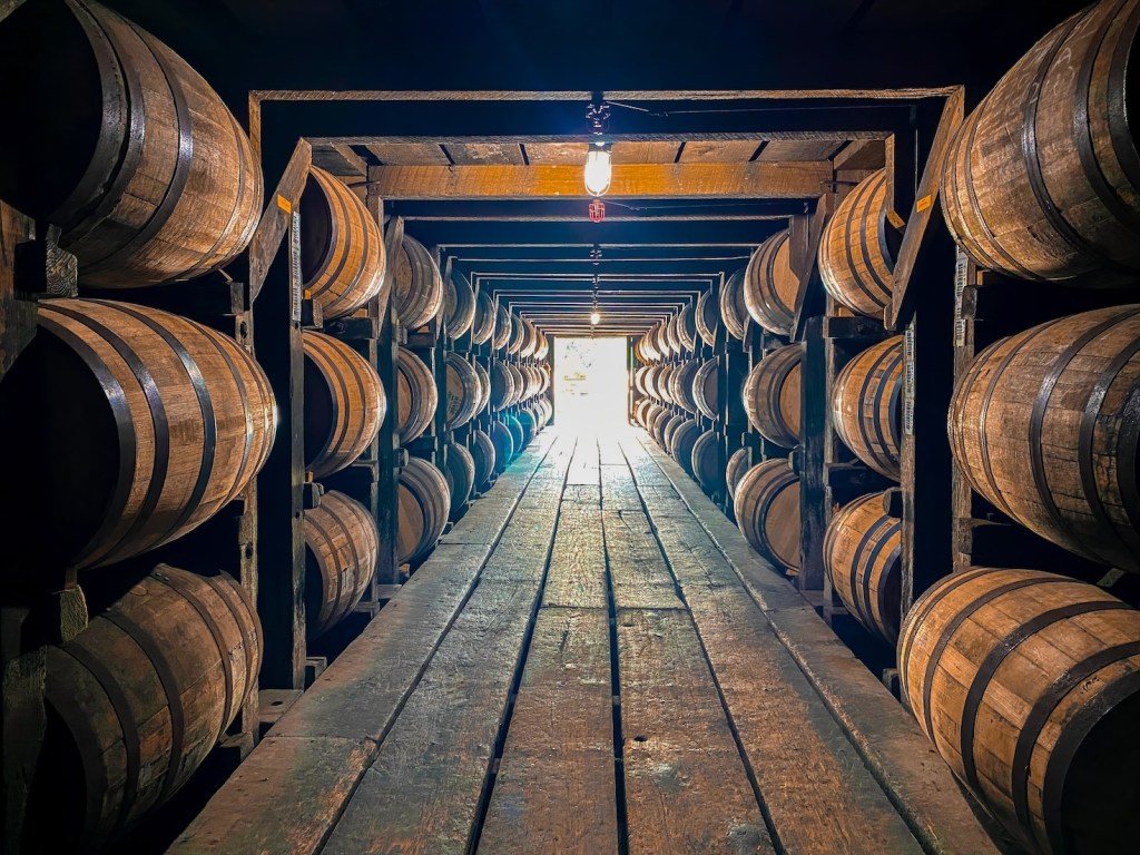 A photograph of bourbon barrels in a rickhouse