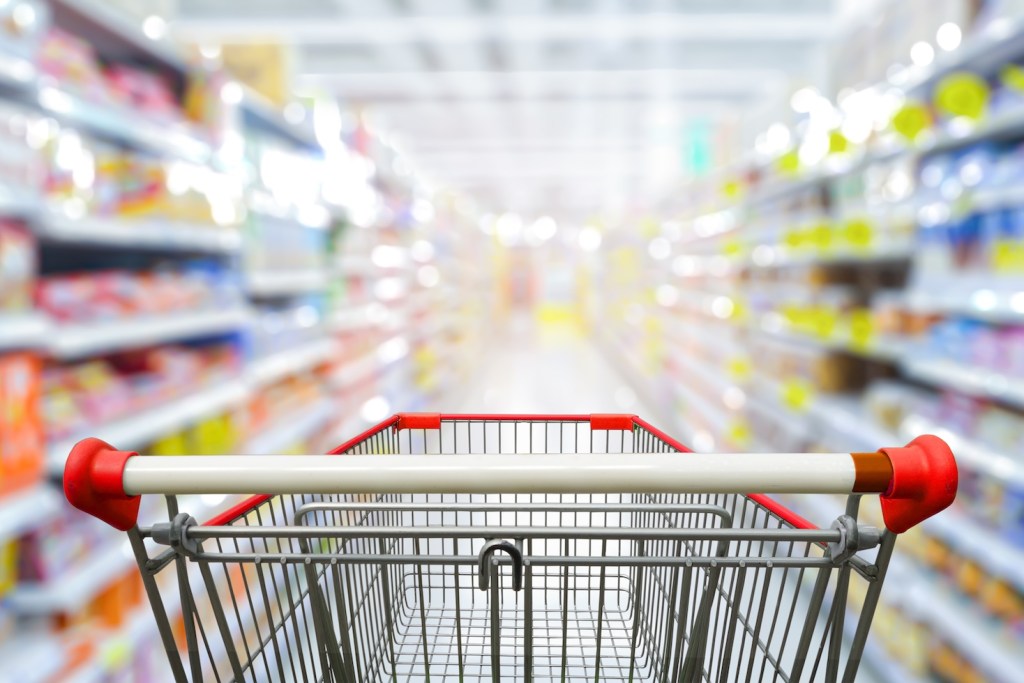 Shopping cart in the aisle of a store.