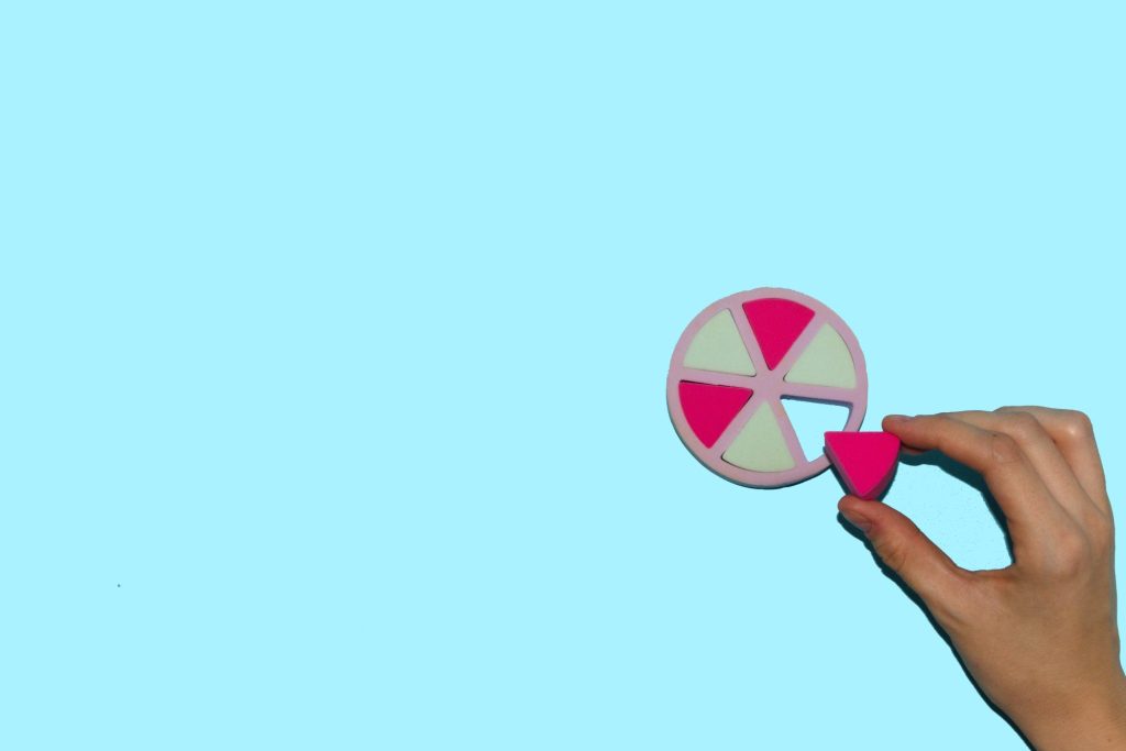 A circle with six pieces and one being taken out.