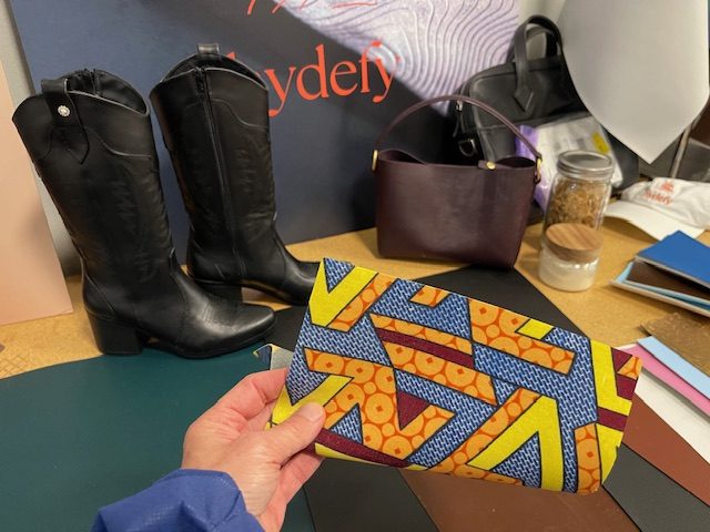 Hydefy's material appears in demo cowboy boots and purses. The printed fabric pattern is visible on the other side through its attached, semi-sheer layer of the fungus material, showing design possibilities that bovine leather can't provide. Credit: Trellis Group / Elsa Wenzel