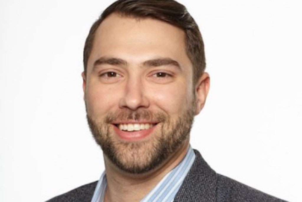 Portrait of man with dark hair.