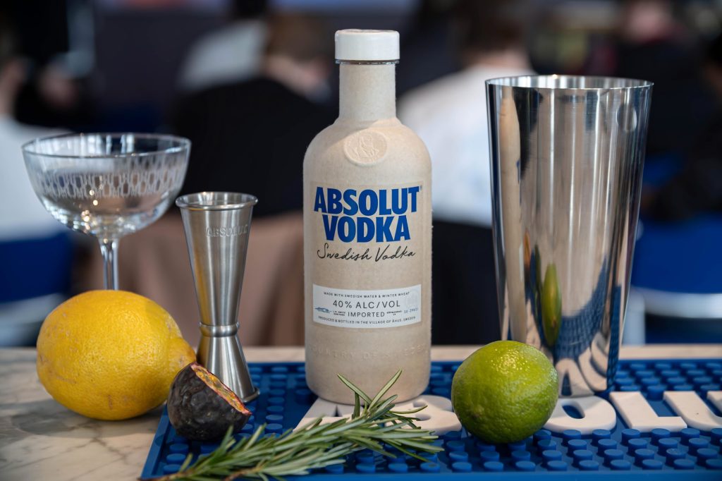 Glass, drink mixers and paper bottle.