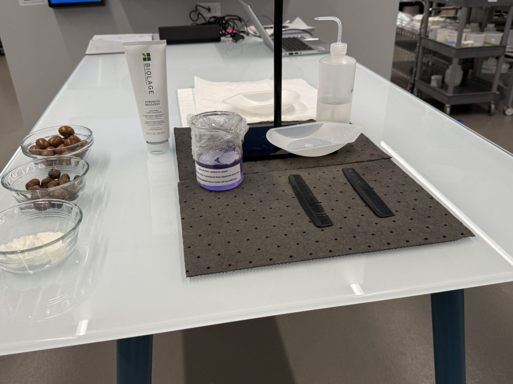 Laboratory table showing shea butter and some L'Oreal products