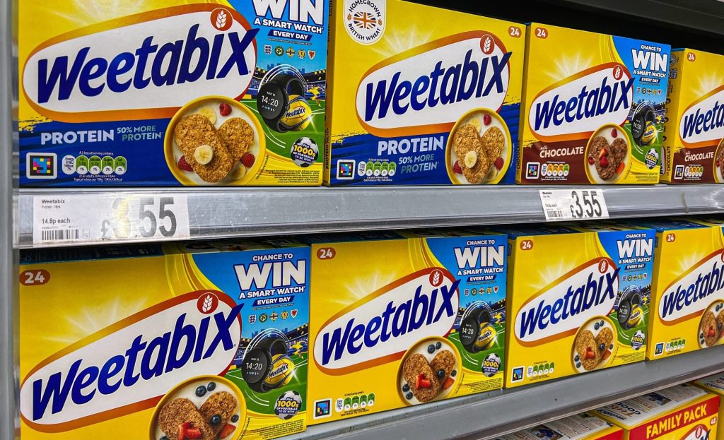 Packets of Weetabix cereal on a supermarket shelf.