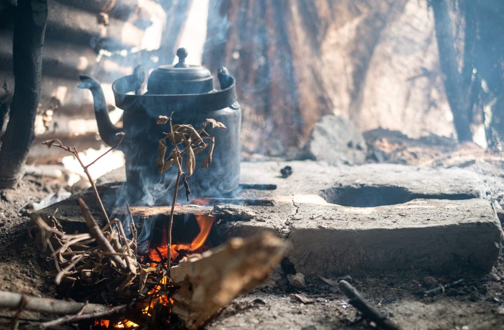 Kettle on mud stove with wood fire , rural Bangladesh kitchen