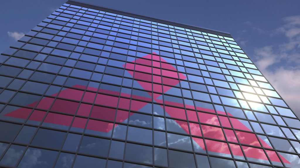 Mitsubishi logo on modern building reflecting sky and clouds, editorial 3D rendering